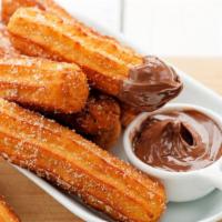Churros Bites · Bite-sized, fried churros topped with sugar and cinnamon. Served with a side of Nutella or c...