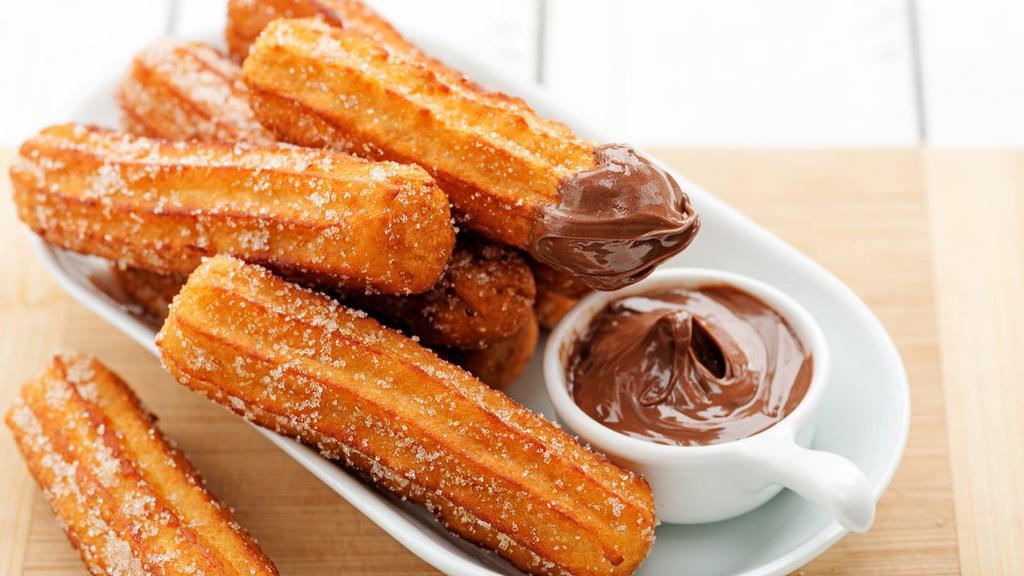 Churros Bites · Bite-sized, fried churros topped with sugar and cinnamon. Served with a side of Nutella or caramel sauce.