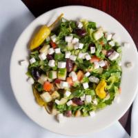 Greek Salad  · lettuce, tomatoes, cucumber, olives and feta cheese drizzled with Greek vinaigrette.