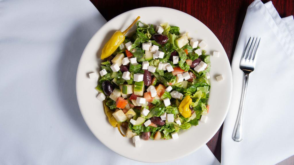 Greek Salad  · lettuce, tomatoes, cucumber, olives and feta cheese drizzled with Greek vinaigrette.