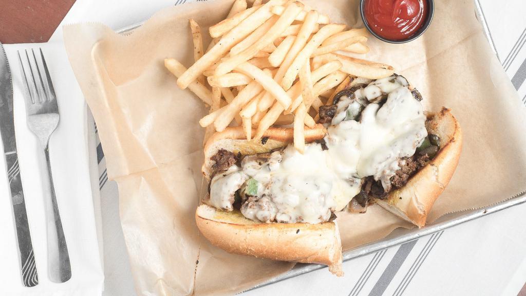 Philly Cheese Steak · Shaved rib-eye steak with grilled onions, sautéed mushrooms, and melted white American cheese served on a toasted roll.