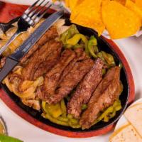 Steak Fajitas · Served with warm soft flour tortillas, signature salsa, Cheddar Jack cheese, and sour cream.