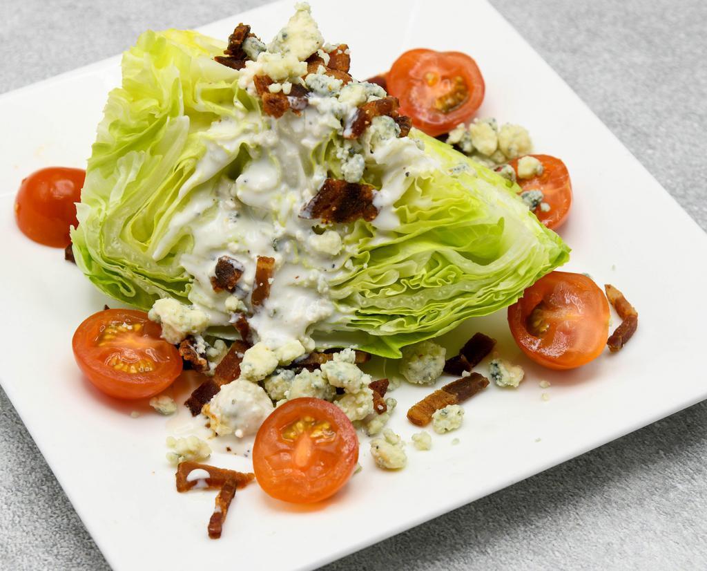 Iceberg Lettuce Wedge · Iceberg, cherry tomatoes, crisp bacon & danish blue cheese dressing.