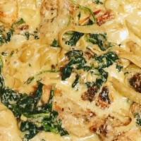 Chicken Florentine  · Fettuccine Pasta covered w/Chicken Spinach and Sundried Tomatoes in a creamy garlic sauce.