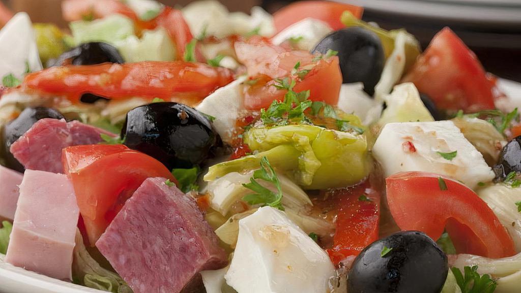 Italian Antipasto Salad · Genoa salami, ham, provolone cheese over romaine lettuce with tomatoes, green and black olives, sweet peppers and onions.