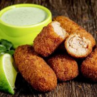 Ham Croquettes · A Cuban favorite. Five ground ham cakes breaded and deep fried served with our homemade cila...