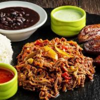 Ropa Vieja (Shredded Beef) Plate · Slow cooked shredded beef in a tomato based sauce with peppers and onions served with black ...