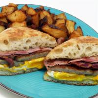 Cowboy Breakfast Sandwich · 2 fried eggs, Ham, Sausage, Bacon and American cheese, served with Home Fries or Grits!