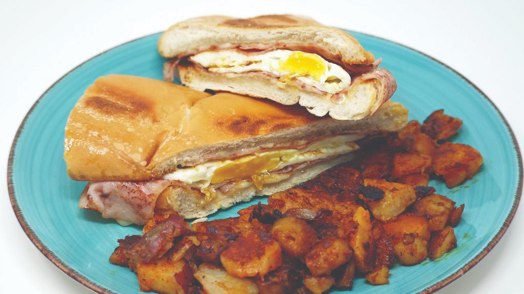 Cuban Breakfast Sandwich · 2 eggs with ham and swiss cheese, served on Cuban toast and a side of home fries or grits