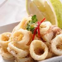 Fried Calamari · Hand-breaded tender rings over a bed of arugula and special dipping sauce.