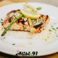 Garlic Butter Glazed Salmon · Grilled salmon topped with a garlic butter sauce, sided with pilaf rice and asparagus.