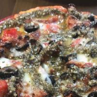 Mediterranean Pizza · Sun-dried tomato, black olives, basil pesto and premium mozzarella cheese.