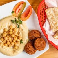 Chickpeas Lovers · Hummus topped with three pieces of falafel olive oil chickpeas salad served with pitta bread.