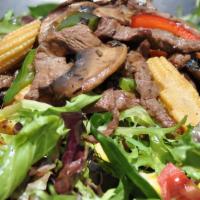 Steak Salad · Lettuce, tomatoes, onions, rib eye steak, dressing.