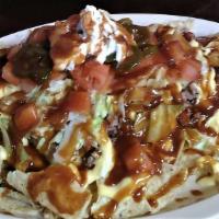 Bbq Nachos · Topped with cheese, shredded lettuce, diced tomatoes, jalapeno peppers, sour cream and BBQ s...