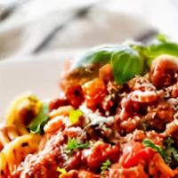 Pasta Bolognese · Ground beef, tomato sauce and fresh herbs. Includes three garlic bread.