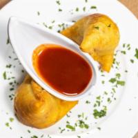 Vegetable Samosas · Triangular puffed-pastry stuffed with cubed potatoes, green peas, carrots and mildly spiced ...