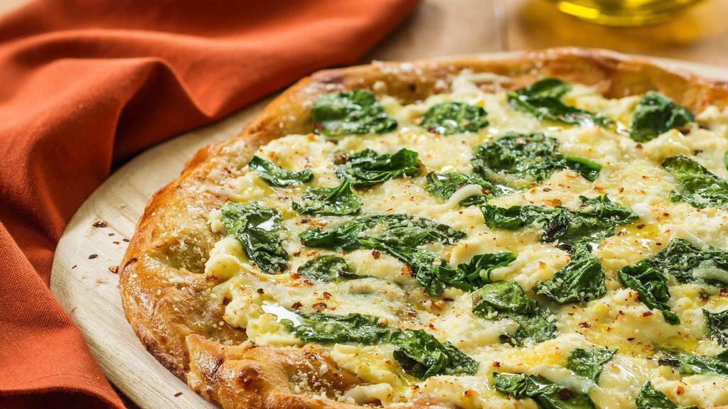 Spinach Ricotta Pizza · White pizza with spinach, ricotta, and fresh mozzarella.
