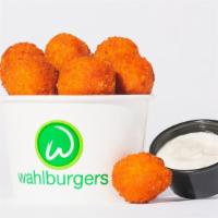 Buffalo Chicken Wahlbites · Bold fried Buffalo chicken bites served with a tangy blue cheese sauce 590 Cal.