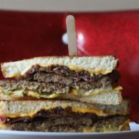 The Super Melt · 2 beef burger patties, government cheese, bacon, caramelized onions, pickles, & housemade mu...