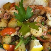 Octopus And Shrimps Salad · Poached and sautéed octopus Ligurian style, sautéed shrimps with potatoes, Italian olives, g...