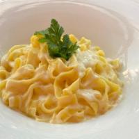 Fettuccine Parmigiano · Handmade fresh fettuccine pasta with Parmigiano cheese sauce, Parmigiano cheese.