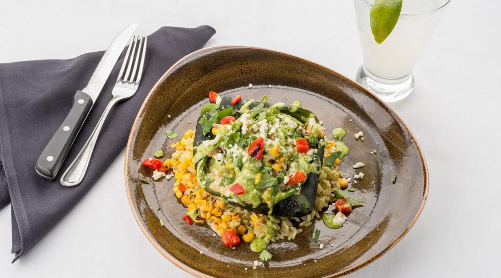 Relleno De Camarones · Shrimp, Monterey jack, vegetable and mushroom stuffed roasted green chili, with avocado, roasted red pepper and poblano sauce, on charred street corn and cilantro lime rice.