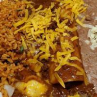 Beef · Ground sirloin enchiladas, with chili con carne sauce and cheddar cheese.