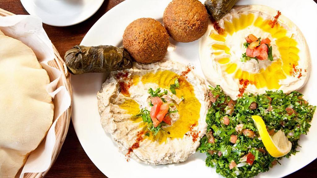 Meze Plate · An assortment of hummus, falafel and baba ghanouj served with tahini sauce and pita bread.