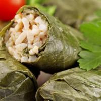 Stuffed Grape Leaves / Dolmas · Delicious stuffed grape leaves with rice, tomatoes and onion served with tzatziki sauce.