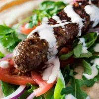Adana Kabab · Hand chopped beef and lamb seasoned with spicy red peppers and special spices served in pita...