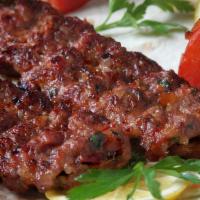 Adana Kabab · Two skewers of charbroiled ground lamb minced twice seasoned with a special spices.
