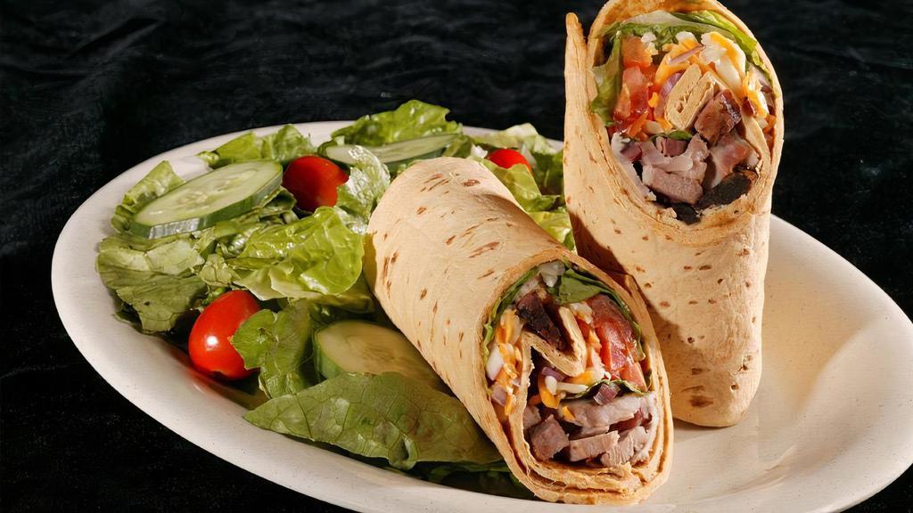Southwest Wrap · A flour tortilla filled with your choice of smoked turkey breast, bar-b-q pork or mesquite grilled chicken breast and corn, black beans, olives, red onion, cheddar jack cheese and chipotle sauce.