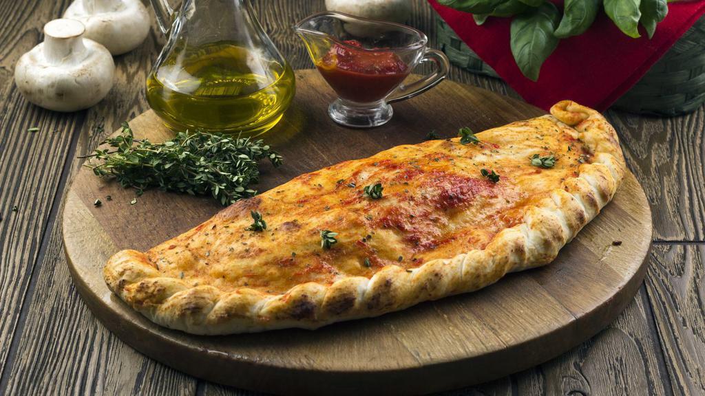 Calzone With Meatballs And Onions · Mouthwatering 16 inch calzone stuffed with Meatballs, onions, and Ricotta and Mozzarella Cheese.