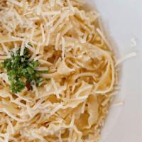 Fettuccini Alfredo · Fettuccini pasta tossed with our freshly-made cream sauce. Garnished with parsley and freshl...
