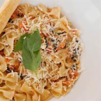 Pomodora Pasta · Farfalle pasta and ripe Roma tomatoes meet a delightfully creamy wine-garlic sauce accompani...