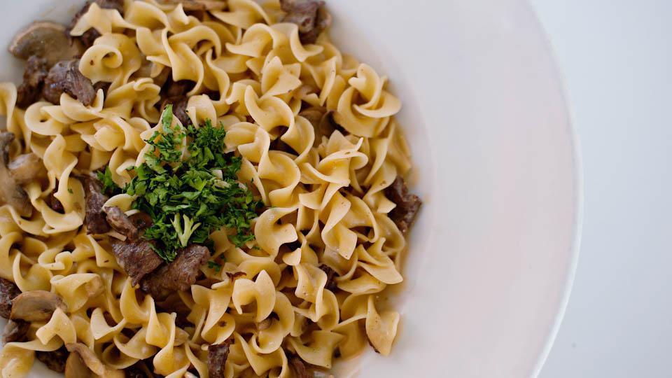 Beef Stroganoff · Wavy egg noodles sautéed with tender beef sirloin and mushrooms, tossed in a classic stroganoff sauce.