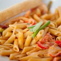 Spicy Cajun Pasta · Penne pasta tossed with our rustic tomato cream sauce, scallions, fresh yellow onions and re...