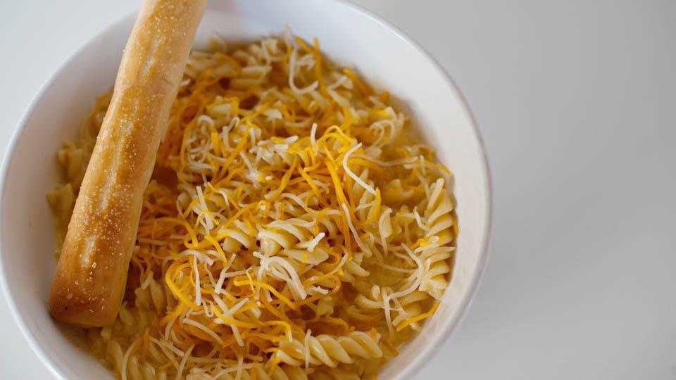 Three-Cheese Macaroni · Fusilli pasta with a special blend of melted cheeses and fresh cream, finished with a generous portion of shredded cheddar and Monterey jack cheeses.