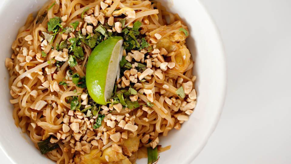 Pad Thai Noodles (Cannot Be Made Gluten Free) · Rice noodles, tossed in a classic Thai sauce with bean sprouts, scallions, crushed peanuts and fried egg. Garnished with freshly cut cilantro and a lime wedge.