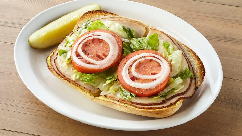 Ham Or Turkey Sub · Your choice of ham or turkey, mayo, mustard, lettuce, tomatoes, onions, provolone cheese and Italian dressing. 720 cal.