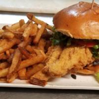 Hand Breaded Beer Battered Fish Sandwich (6-7Oz) · Cod with tartar sauce and side.
