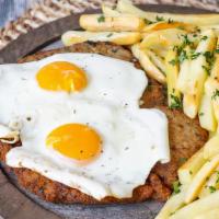 Chicken Milanesa A Caballo · Topped with 2 fried eggs served with french fries or house salad