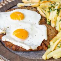 Beef Milanesa A Caballo · Topped with 2 fried eggs served with french fries or house salad