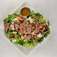 Steak Salad · Sirloin served medium rare on romaine lettuce, blue cheese crumbles, bacon, red potatoes, to...