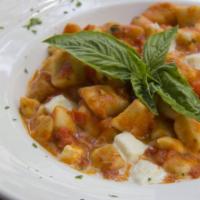 Gnocchi Sorrentina · Homemade gnocchi, chopped tomatoes, fresh mozzarella, parmigiano