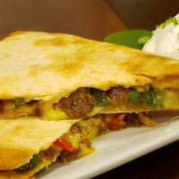 Steak Quesadilla · Grilled steak, grilled onions and peppers, shredded cheese and cilantro sauce. Add avocado f...