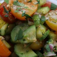 Israeli Salad · Tomato, cucumber and onion with parsley, olive oil and lemon juice