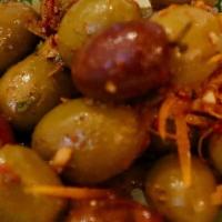 Marinated Olives · Olives marinated with rosemary, lemon and orange zest in olive oil