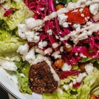 Falafel Salad · Romaine lettuce, Israeli salad, sumac slaw, feta, sunflower seeds, chickpeas, hard-boiled eg...